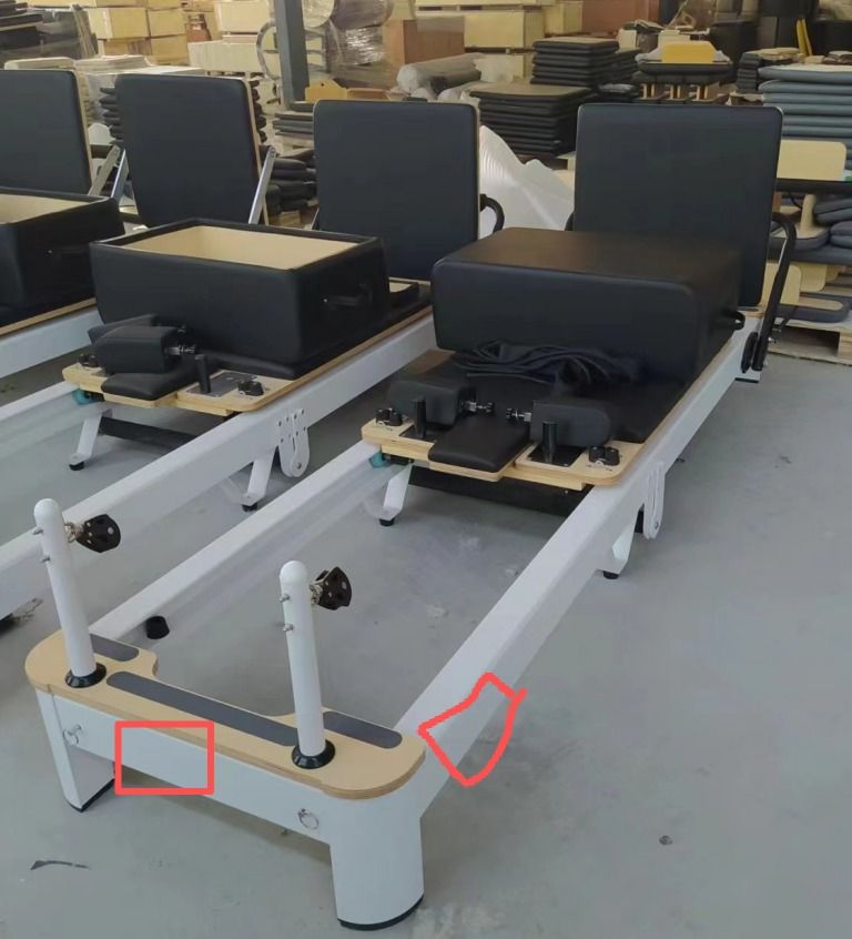 Two reformers in the factory, with the logo positions marked on the maple end cap.