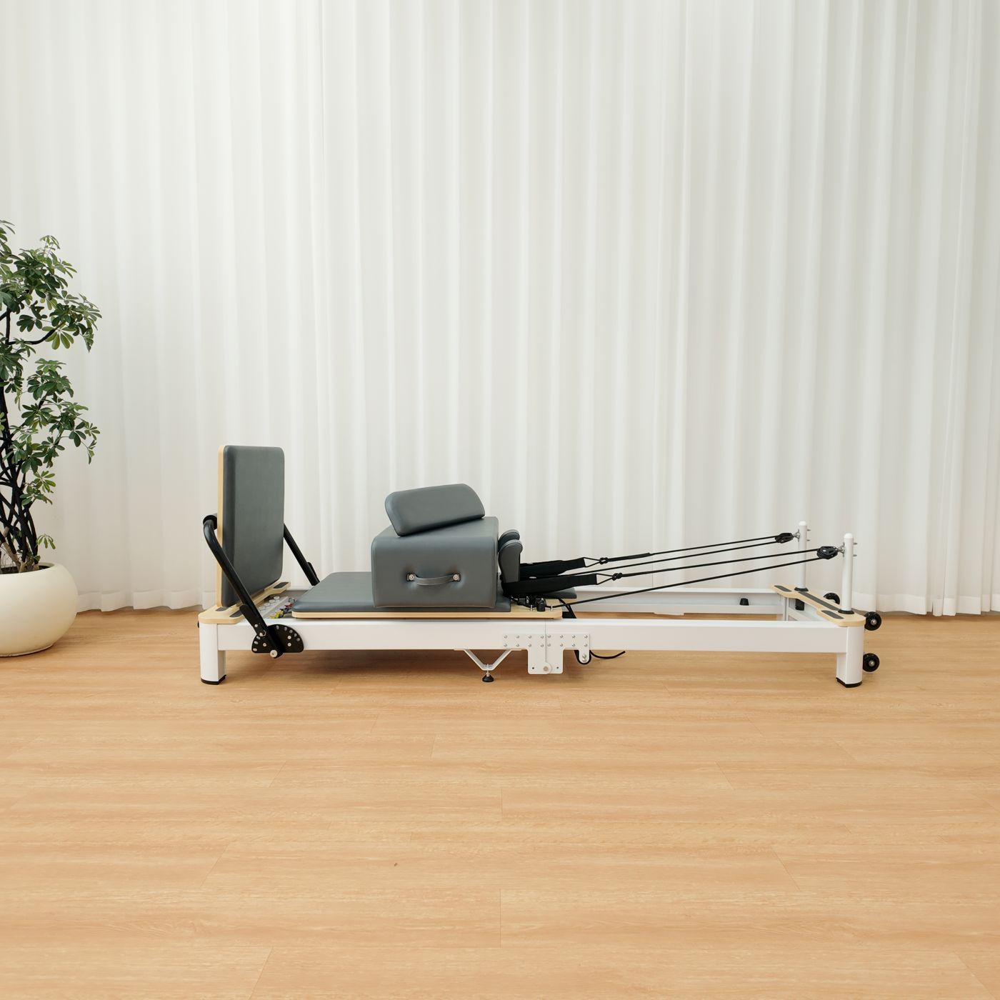 The reformer unfolded, side view, with the sitting box and jumpboard fitted.